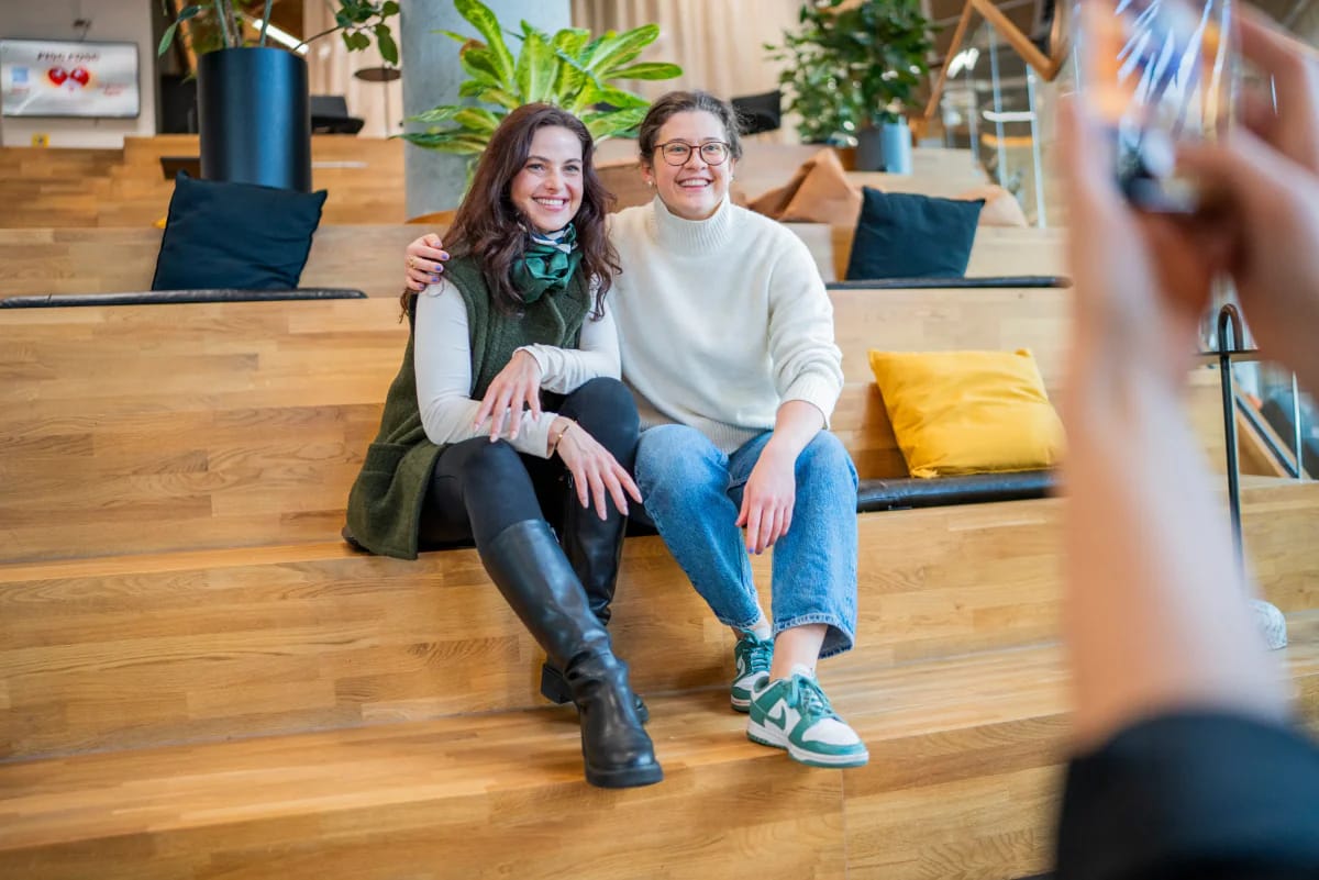 Students sitting on a wooden step